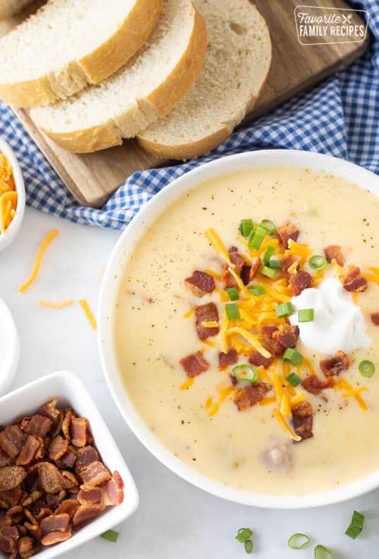 Loaded Potato Soup in a bowl with bread.
