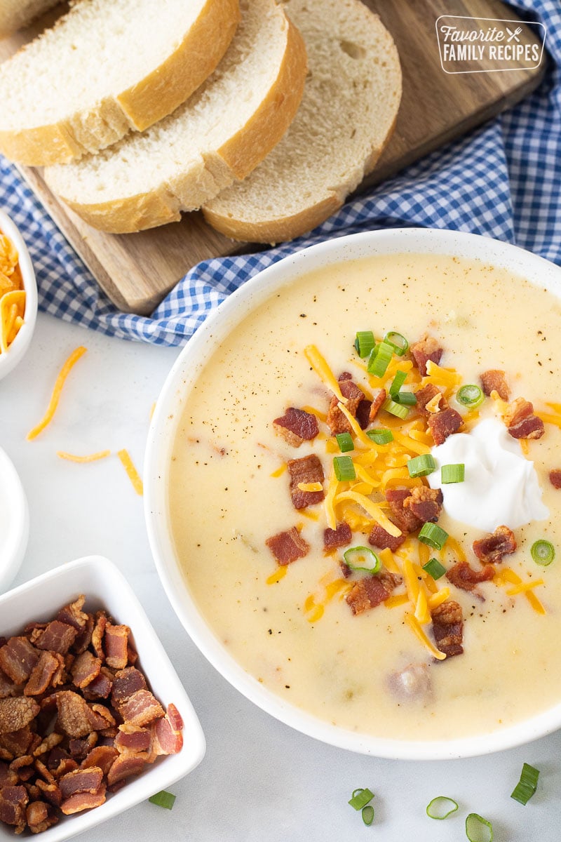 Loaded Potato Soup in a bowl with bread.