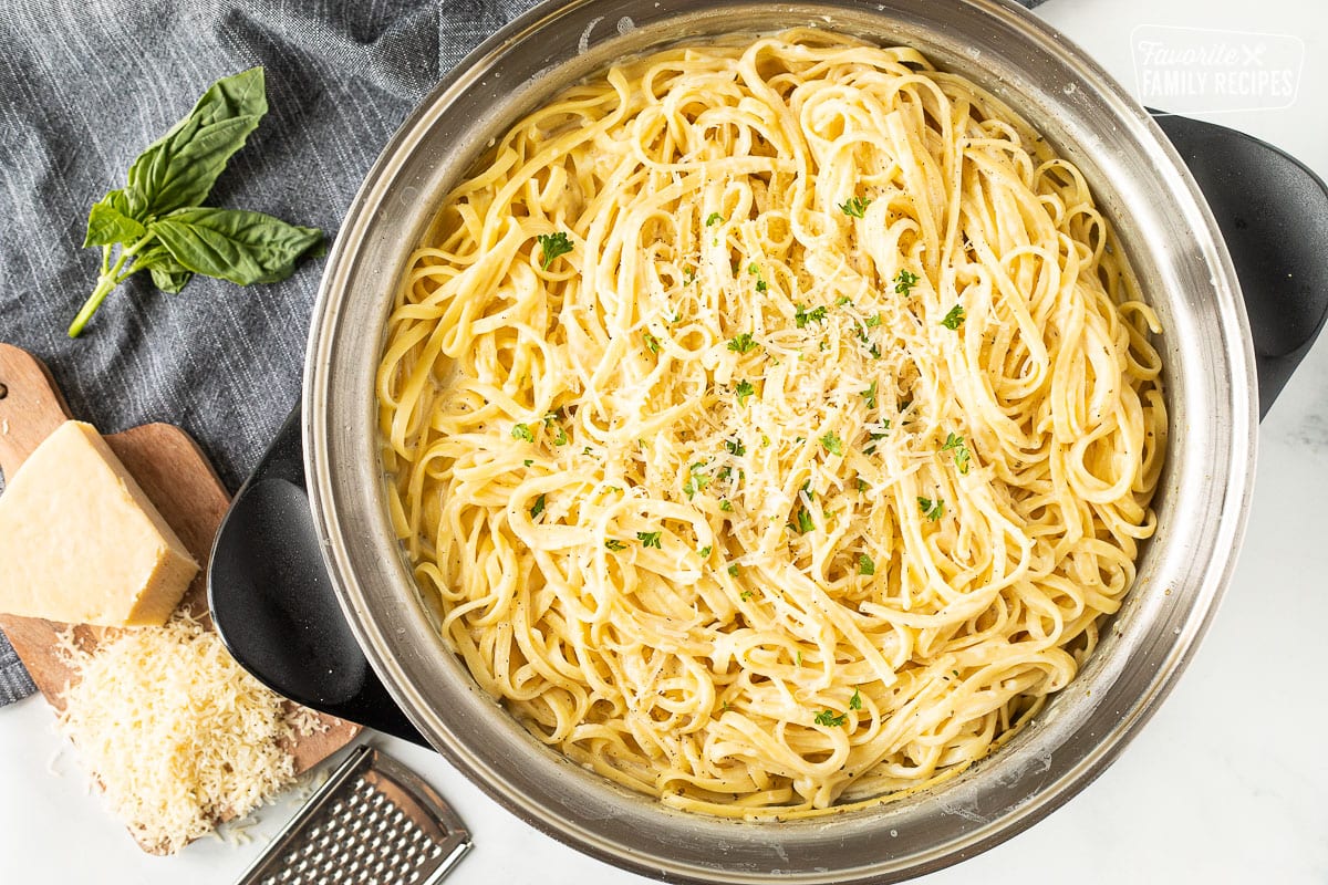 One Pot Creamy Garlic Noodles garnished with fresh parmesan and parsley.