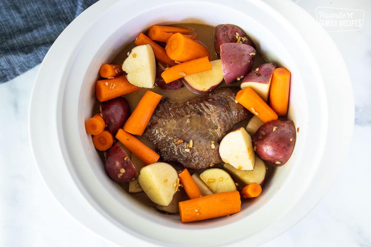 Adding raw cut carrots and red potatoes to Crockpot Roast Beef.