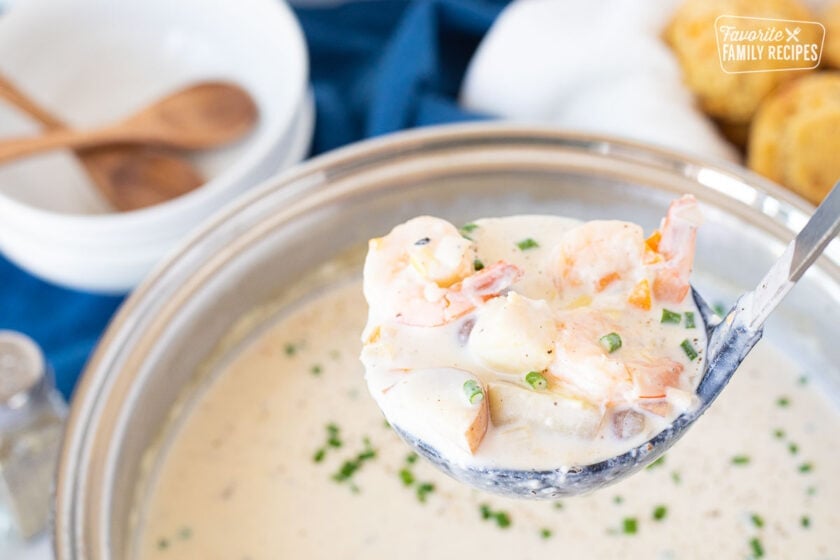 Laddle holding a large scoop of Seafood Chowder.