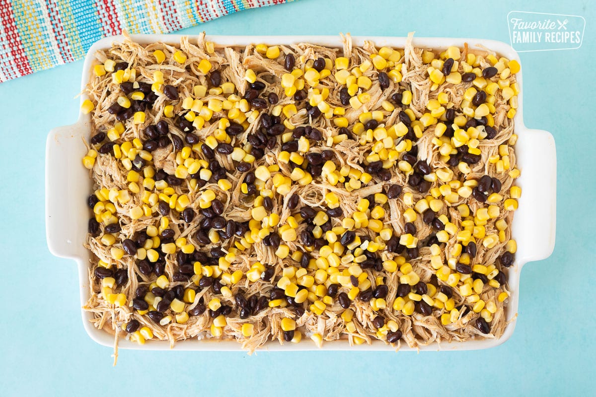 Baking dish with second corn and black bean layer for Mexican Chicken Casserole.