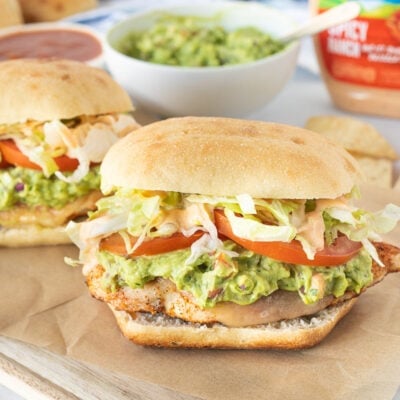 Two Chicken Tortas with tortilla chips.