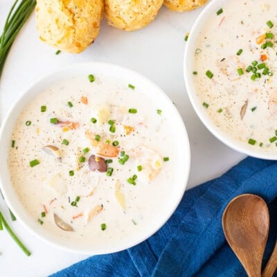 Two bowls of Seafood Chowder with green onions and black pepper.