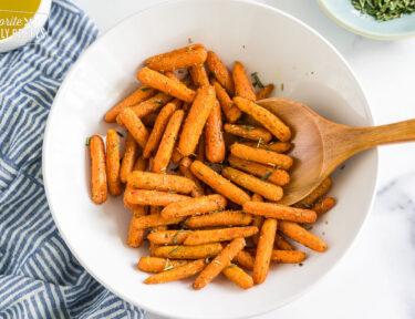 Cooked baby carrots in a bowl