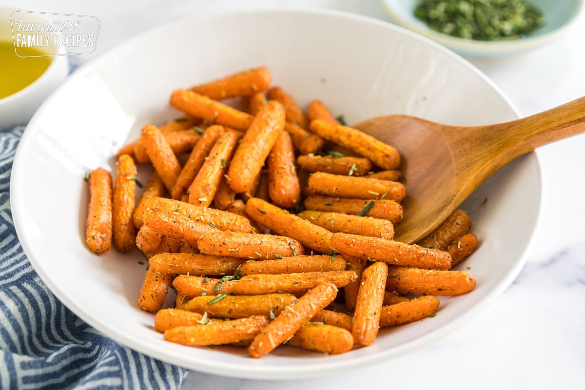 Cooked baby carrots in a bowl.