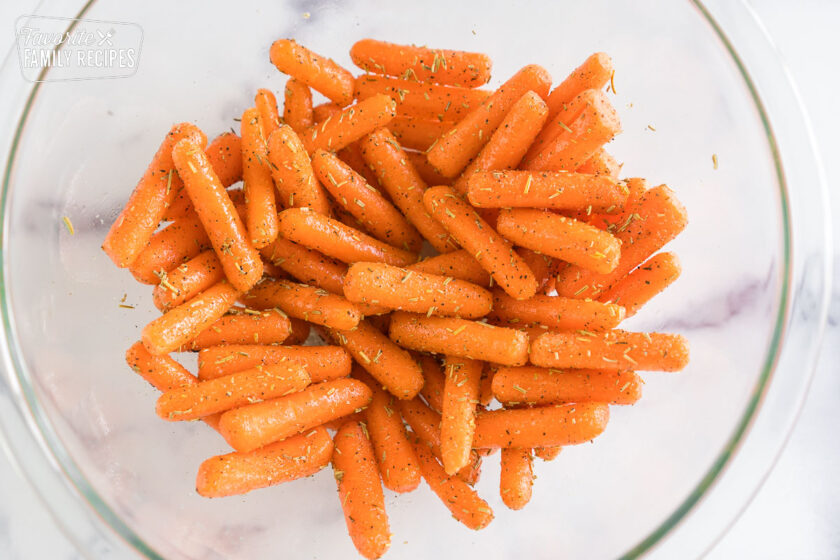 baby carrots coated in olive oil and seasoned with rosemary, salt, and pepper
