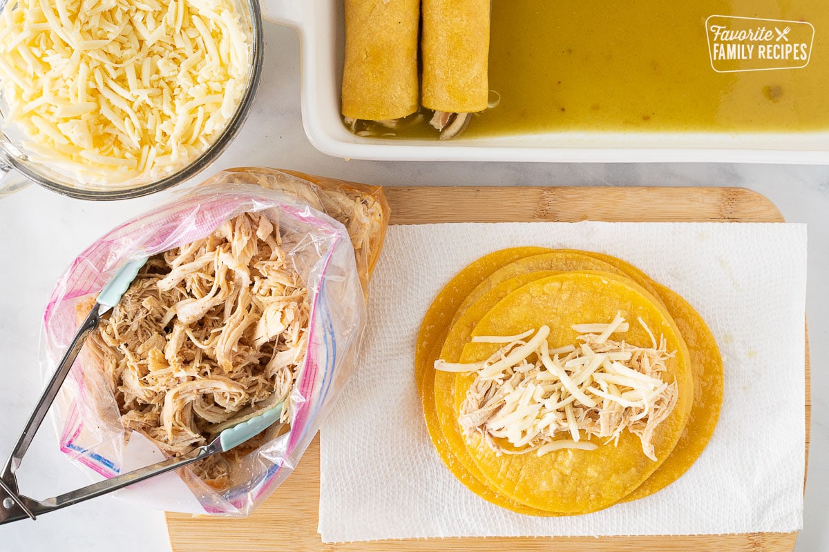 Corn tortillas, shredded chicken, cheese and baking dish with rolled Honey Lime Chicken Enchiladas.