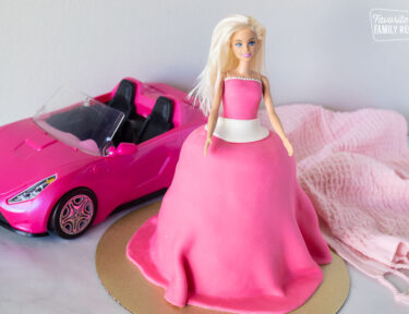 Decorated Barbie Cake in front of Barbie convertible.