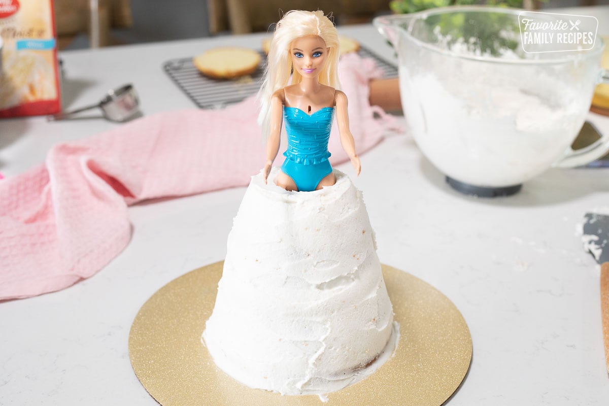 Barbie inside frosted stacked cakes for Barbie Cake.