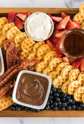 A breakfast charcuterie board with waffles and waffle toppings