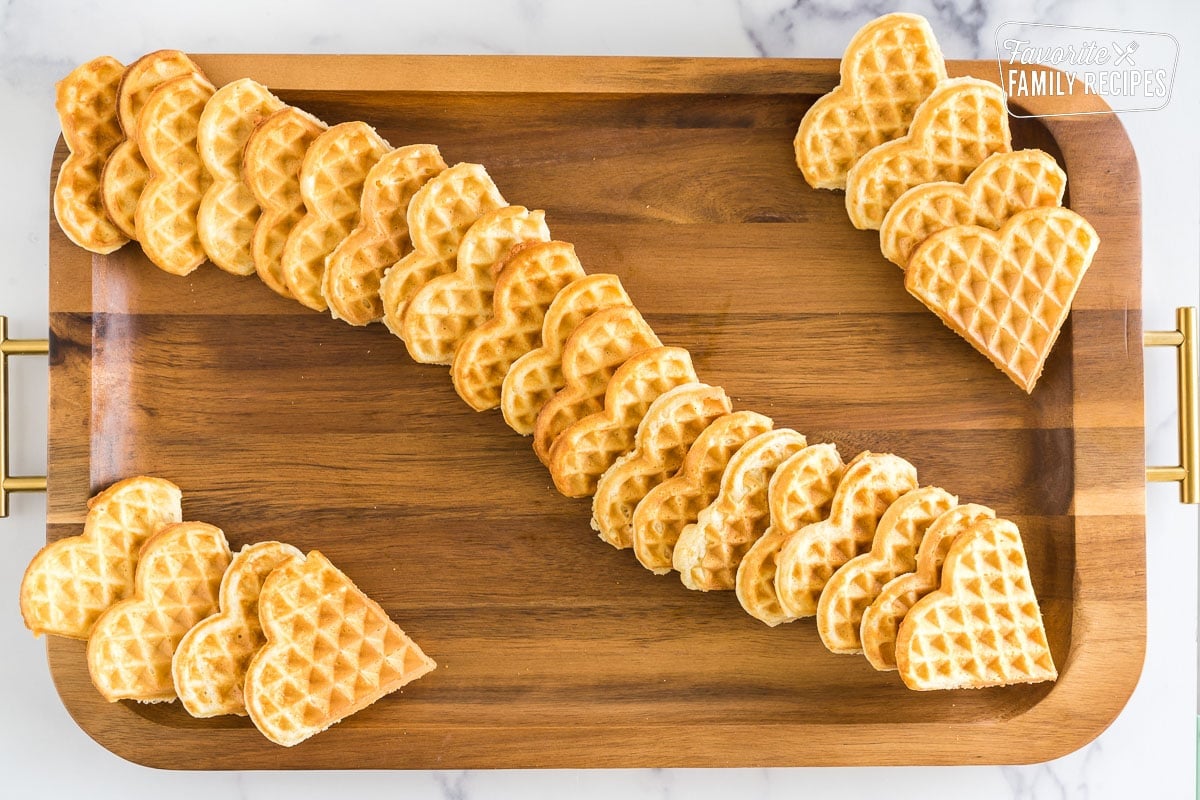 Wooden serving board with heart shape waffles on it