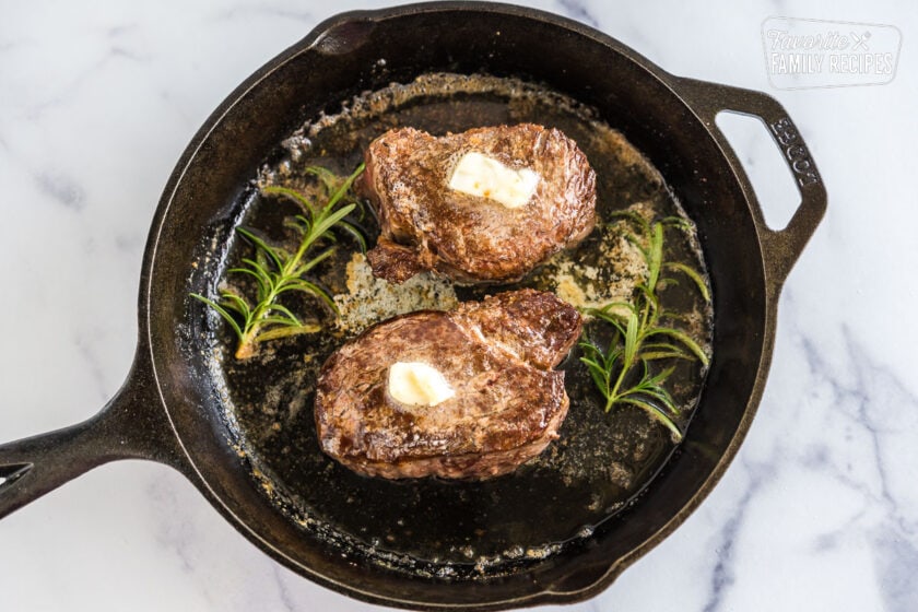 Two filet mignons in a cast iron pan