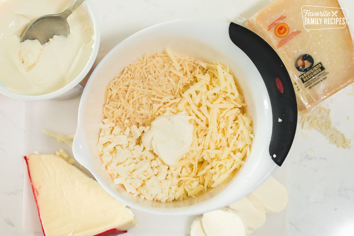 Ricotta, fontina, parmesan, and mozzarella in a mixing bowl