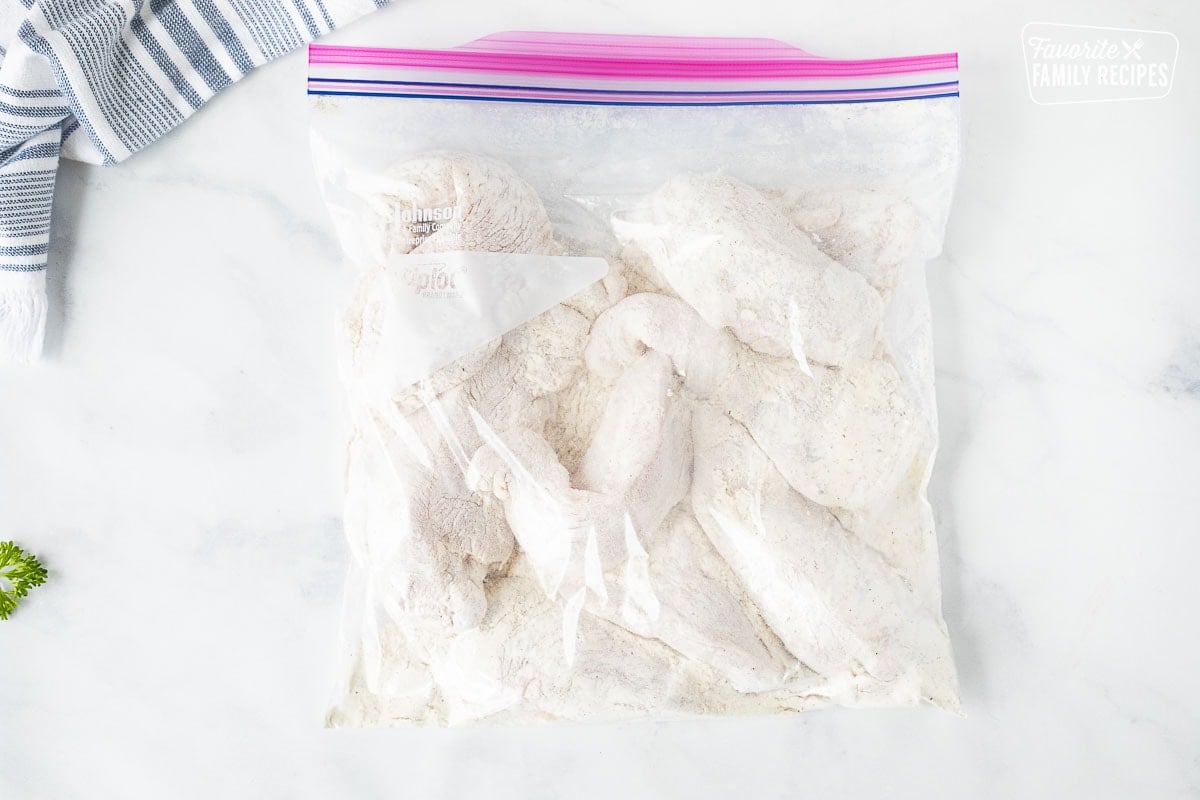 Ziplock bag with coated chicken pieces for Chicken Marsala.