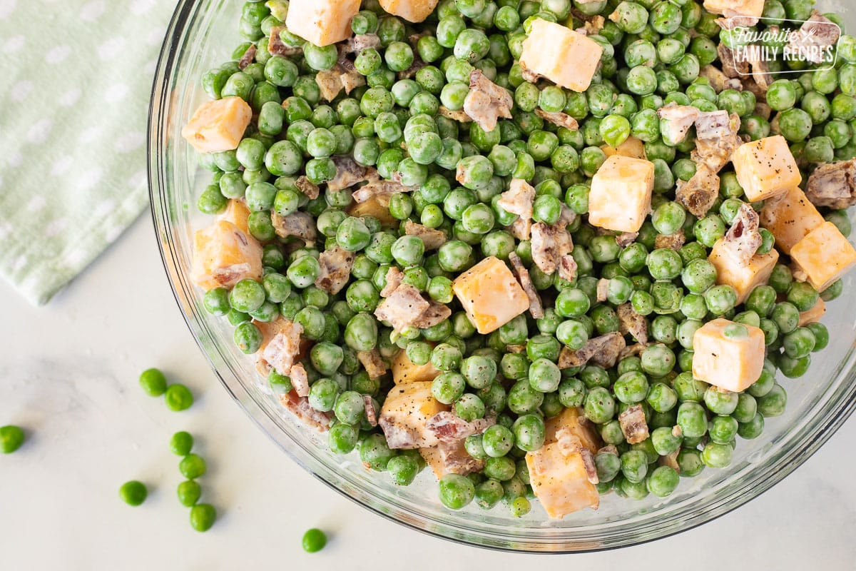 Close up of Green Pea Salad in a large glass bowl.