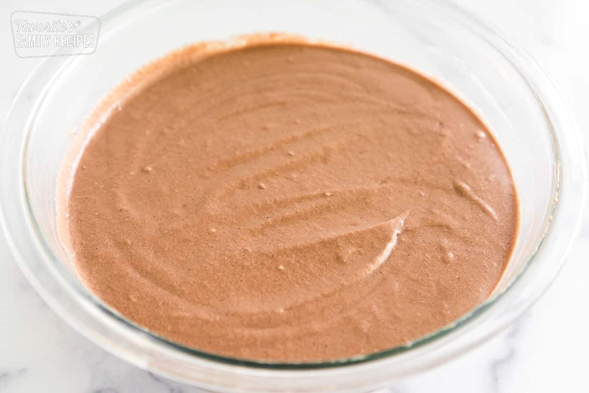 Coca cola cake batter in a large glass bowl