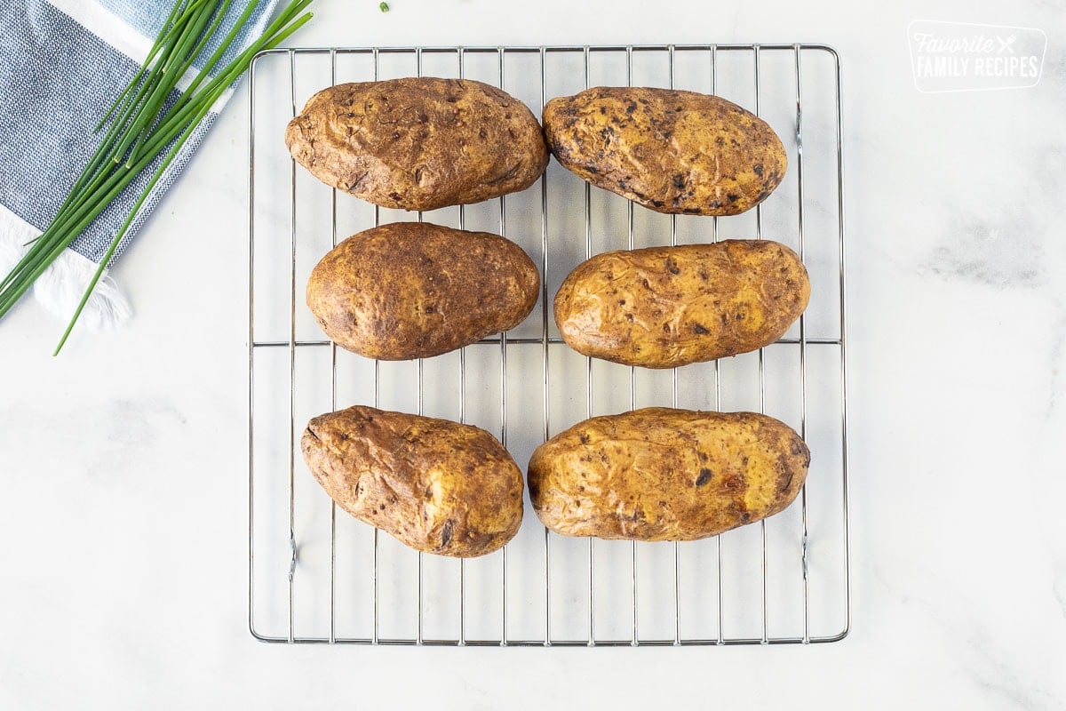 Cooling rack with six baked potatoes for Potato Skins.