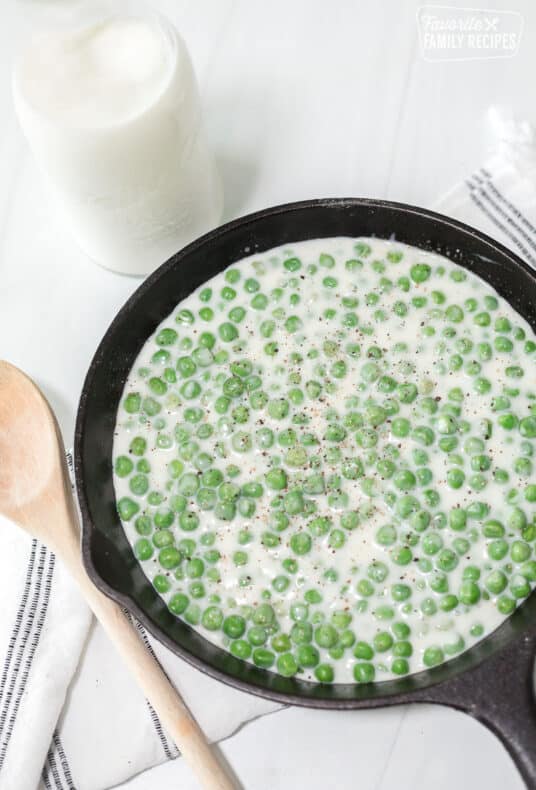 A cast-iron skillet with creamed peas