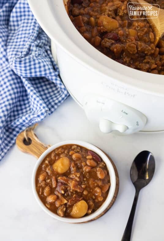 Bowl of Baked Beans next to the Crockpot of Baked Beans.