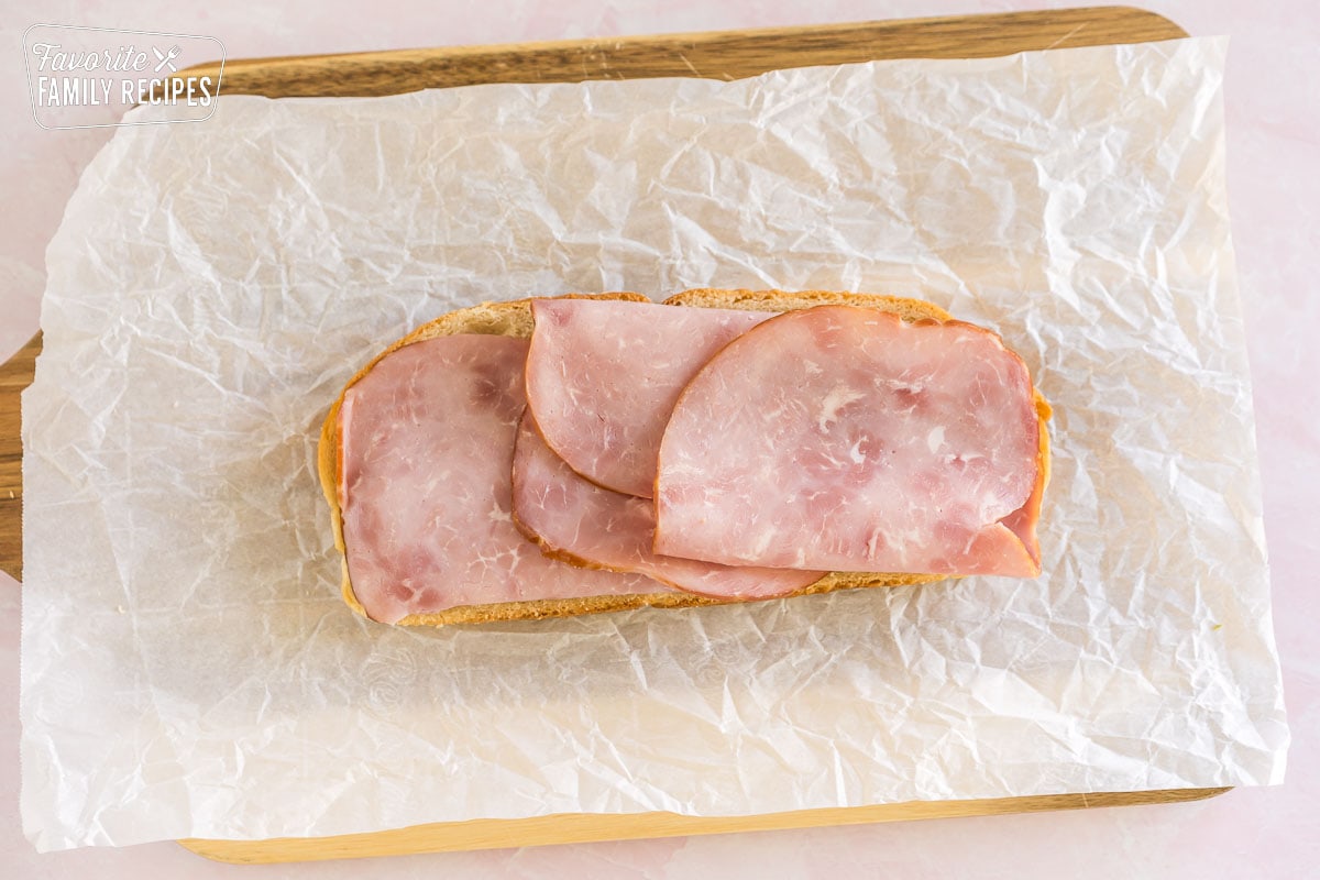 a slice of bread topped with slices of ham