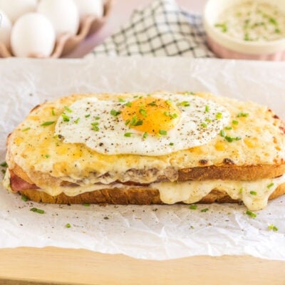 A croque madame topped with pepper and chives