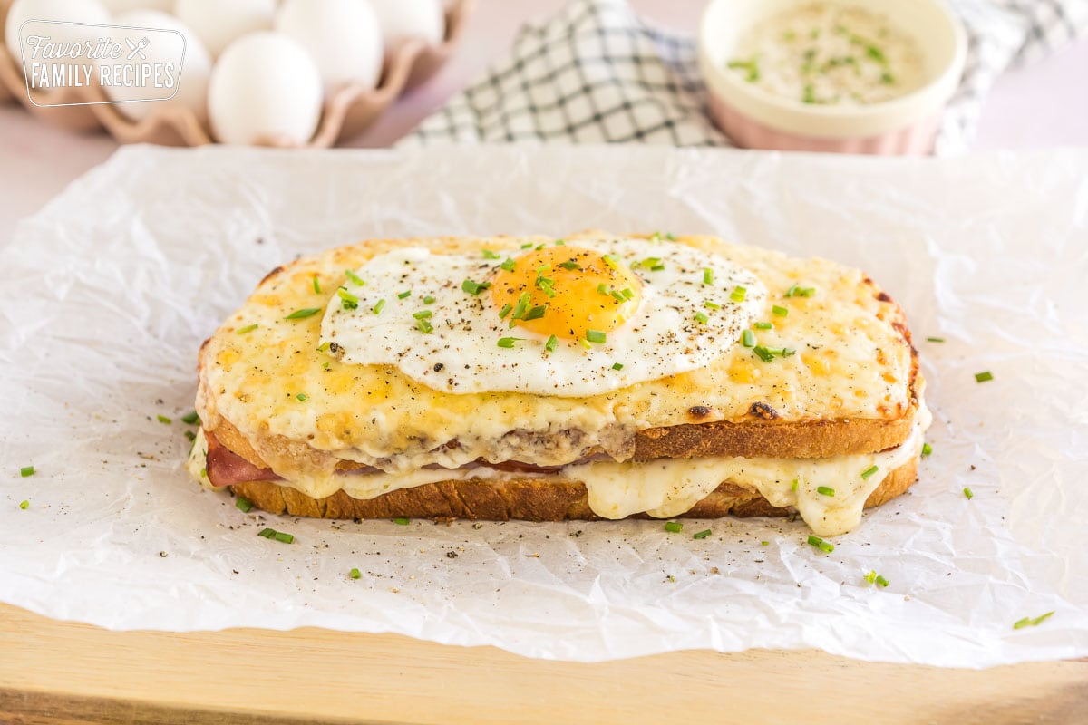 A croque madame topped with pepper and chives