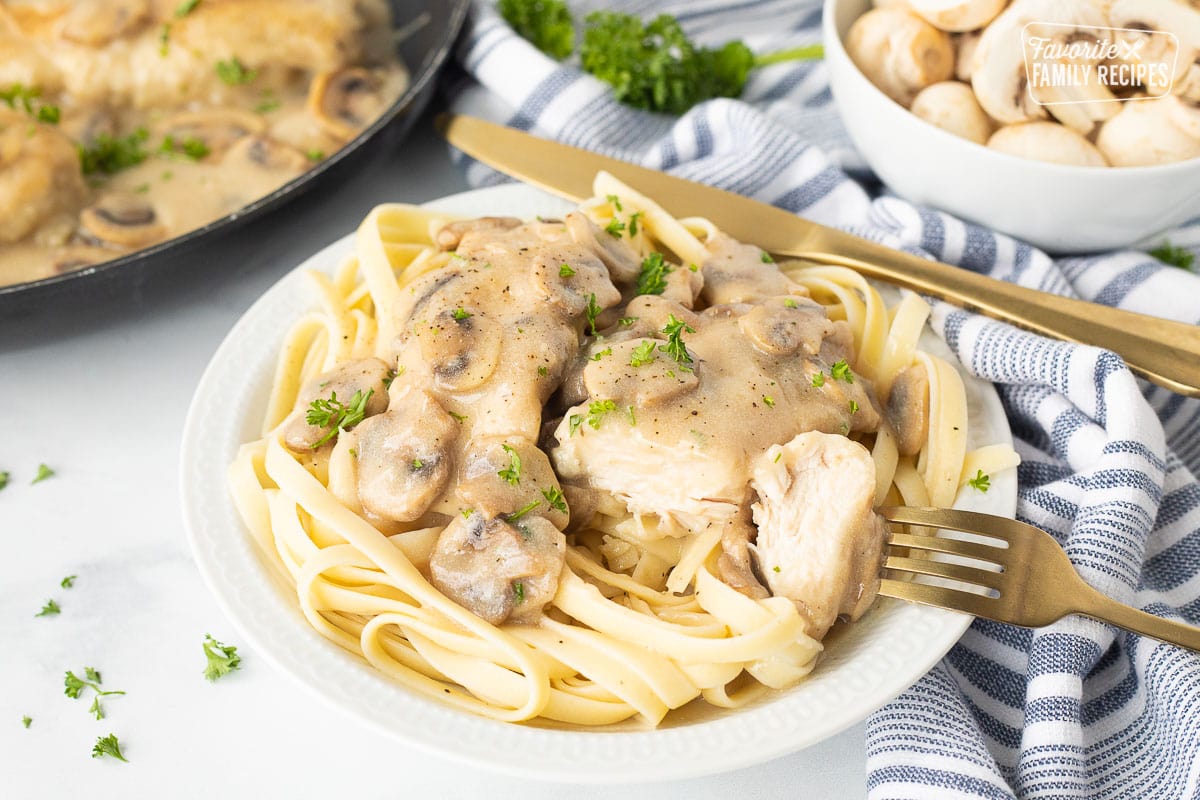 Chicken marsala fettuccine in a rich creamy sauce with sautéed mushrooms over fettuccine noodles