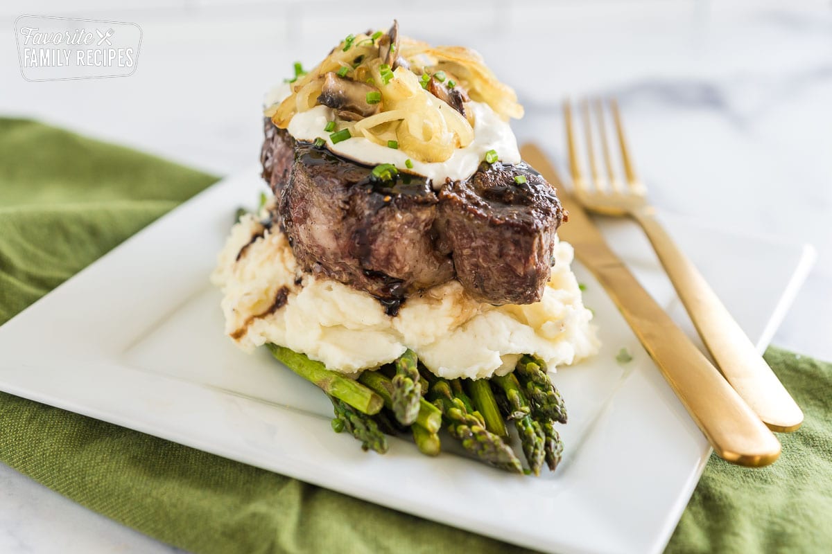 This Fancy Filet Mignon recipe is a winner for Valentine's Day, anniversaries, or birthdays. You will wow your guests with this elevated dish all served up in a eye-catching stack. A fancy filet mignon dinner on a plate.