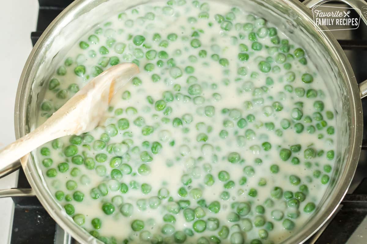 A skillet with creamed peas