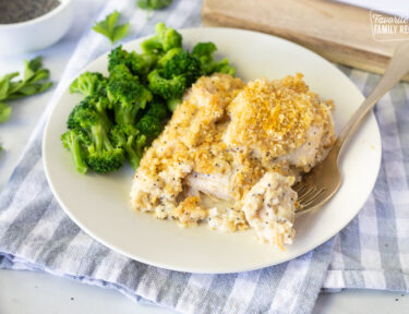 Plate with Poppy Seed Chicken, broccoli and a fork with a piece of Poppy Seed Chicken.