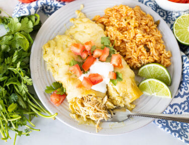 Honey Lime Chicken Enchiladas on a plate with a fork.