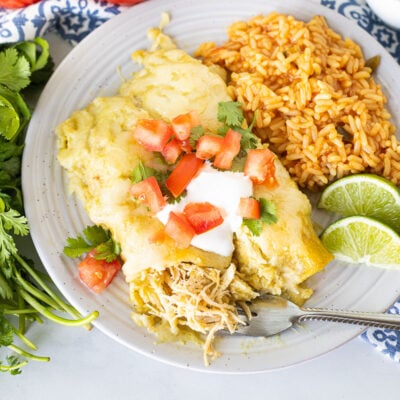 Honey Lime Chicken Enchiladas on a plate with a fork.
