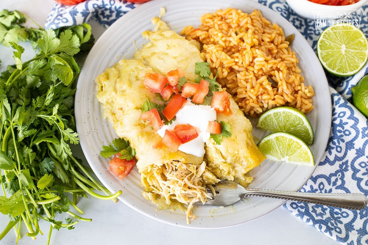 Honey Lime Chicken Enchiladas on a plate with a fork.