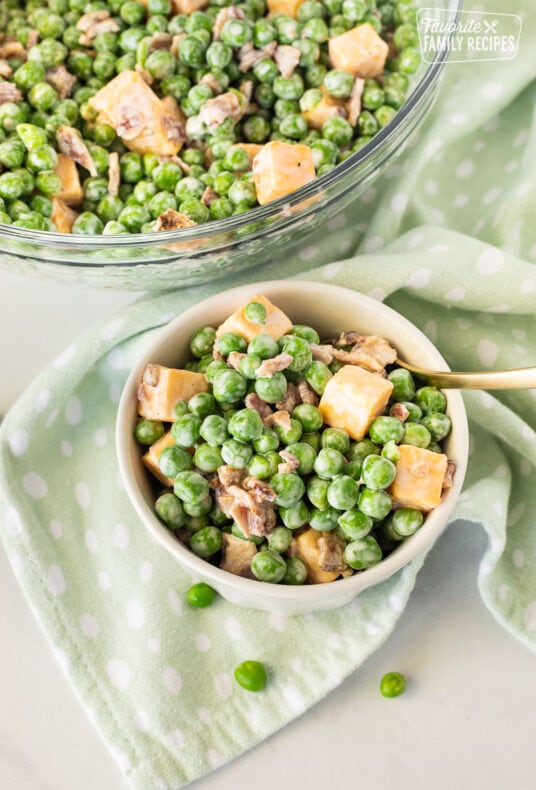 Green Pea Salad in a glass dish with a fork.