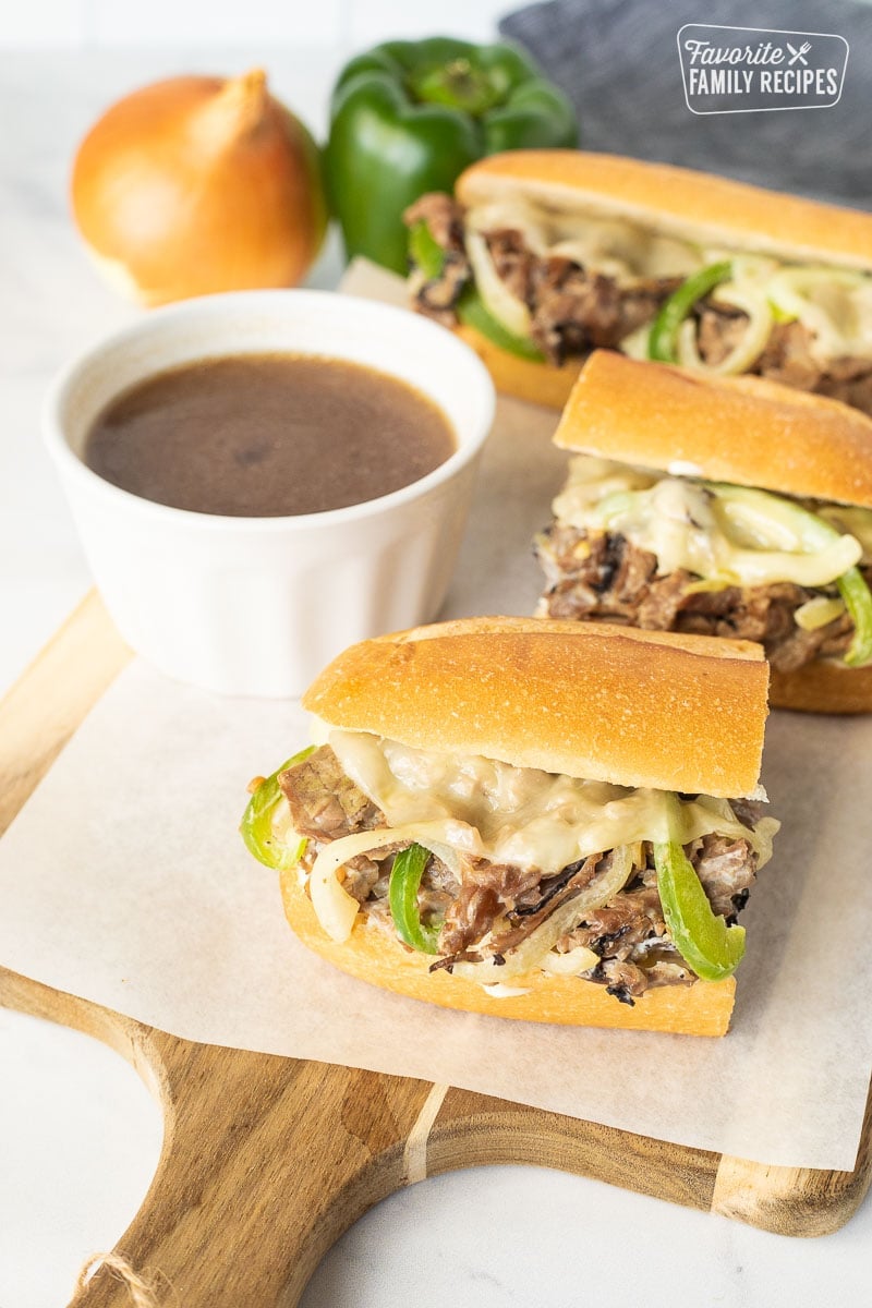 Half of a Philly Cheesesteak with a cup of au jus.