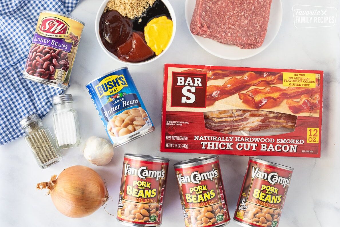 Ingredients to make Baked Beans including bacon, butter beans, ground beef, kidney beans, pork and beans, onion, garlic, salt, pepper, ketchup, bbq sauce, molasses, mustard and brown sugar.