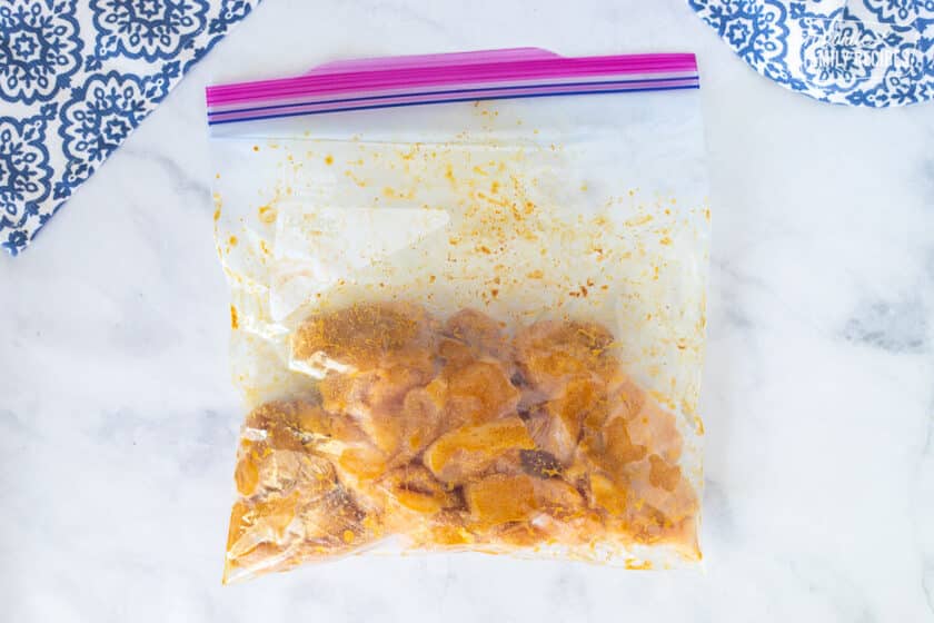 Ziplock back with chicken and spices marinating for Chicken Korma.
