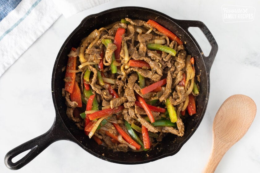 Fajita mixture of steak, bell peppers and onions in a skillet for Steak Fajita Bowls.