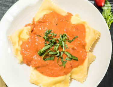 Ravioli with a creamy red sauce over the top