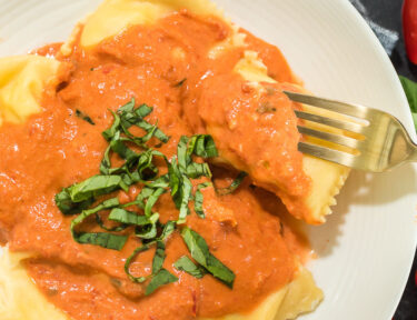 Ravioli with a creamy tomato sauce over the top
