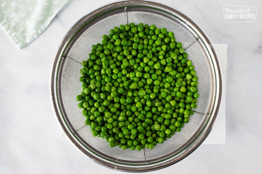 Colander with rinsed green peas for Green Pea Salad.