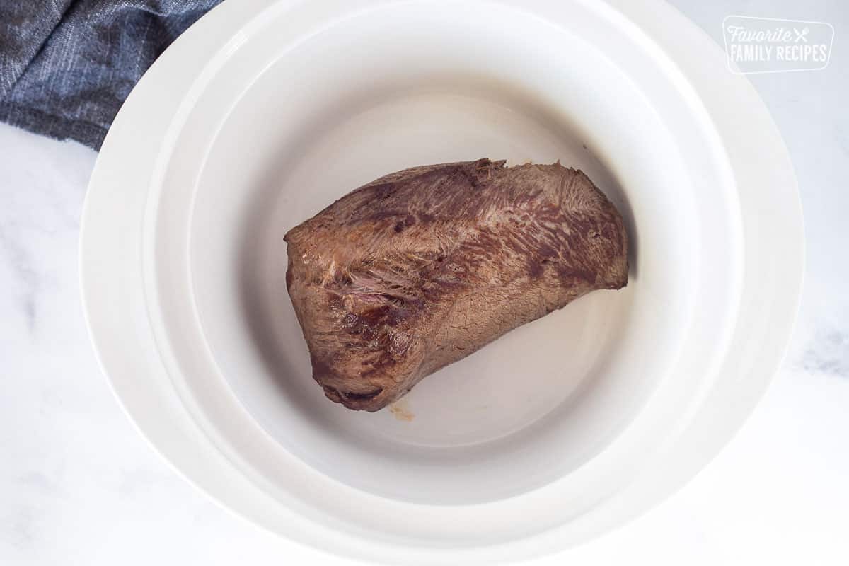 Crockpot with seared beef roast.
