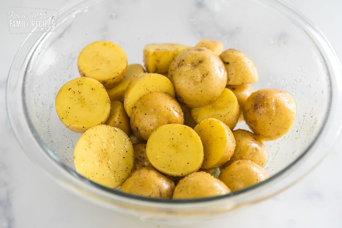 cut and seasoned baby potatoes in a glass bowl