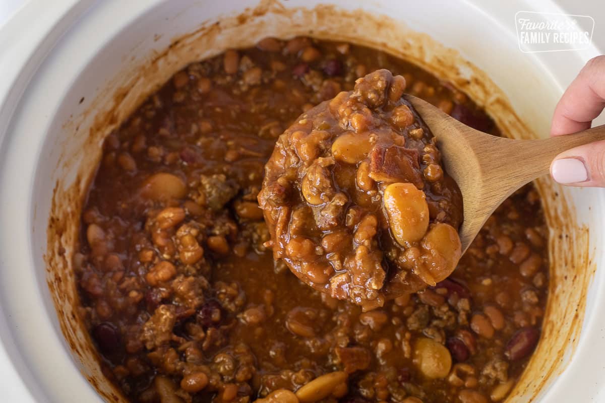 Spoon holding up cooked Baked Beans.