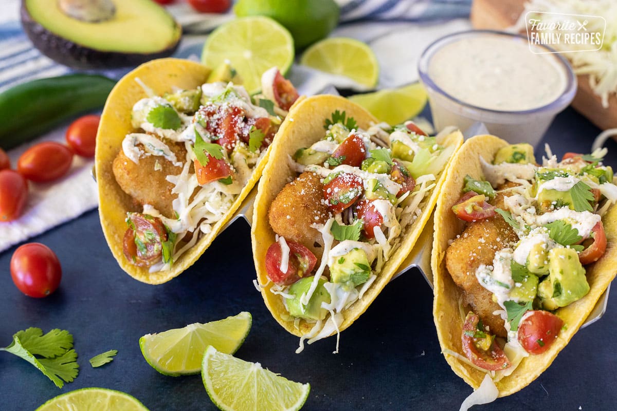 Three Easy Fish Tacos on corn tortillas with pico de Gallo, cilantro cream sauce and cotija cheese.