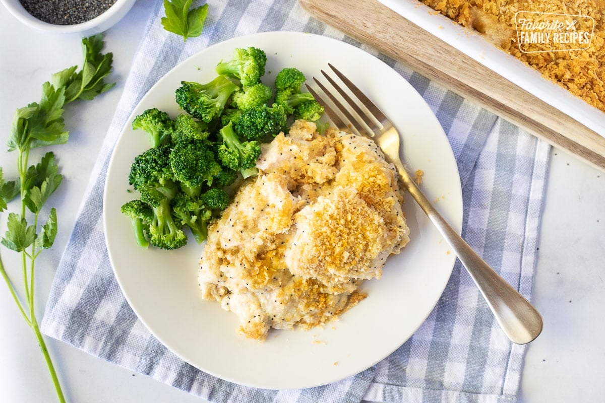 Plate of Poppy Seed Chicken with cooked broccoli and a fork.