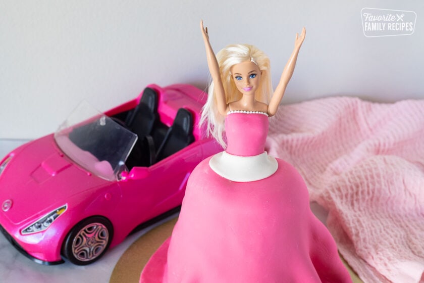 Barbie with two arms up for Barbie Cake.