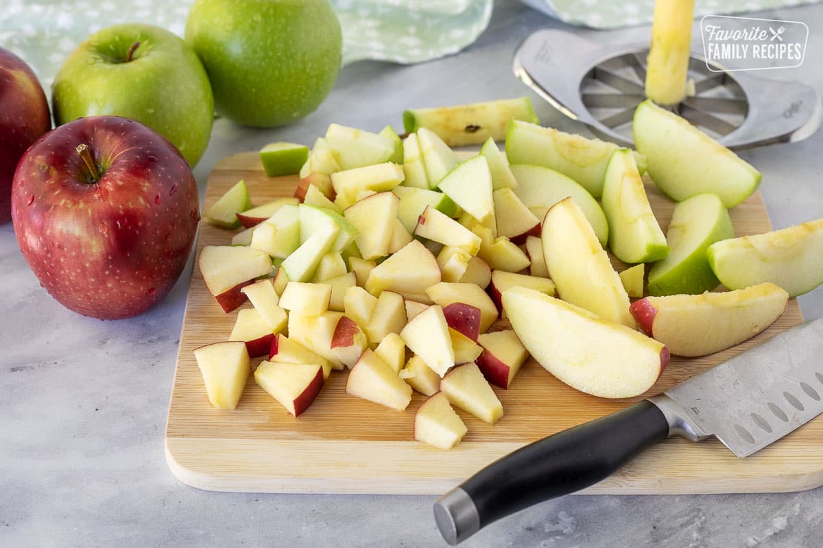 Coring and slicing apples on a cutting board for Waldorf Salad.