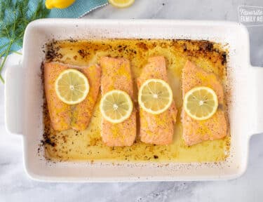 Four pieces of Baked Lemon Salmon in a baking dish.